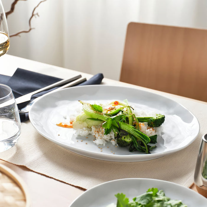 IKEA FORELLTETRA white plate serving rice and vegetables on a table with glasses and napkins