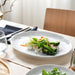 IKEA FORELLTETRA white plate serving rice and vegetables on a table with glasses and napkins
