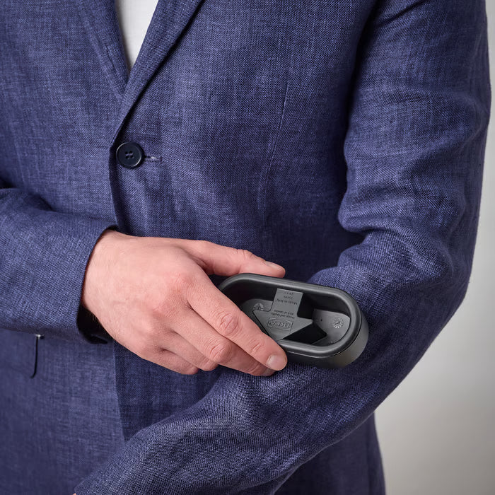 Person holding the IKEA FRUKTPLOCKARE reusable lint brush to remove hair and dust