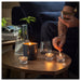 KEA FRUKTSKOG Scented Tealight in Vetiver & Geranium/Black-Turquoise, creating a cozy ambiance with a 3.5-hour burn time