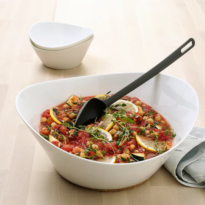 IKEA FULLÄNDAD grey cooking spoon in use with a black frying pan cooking mushrooms on stovetop
