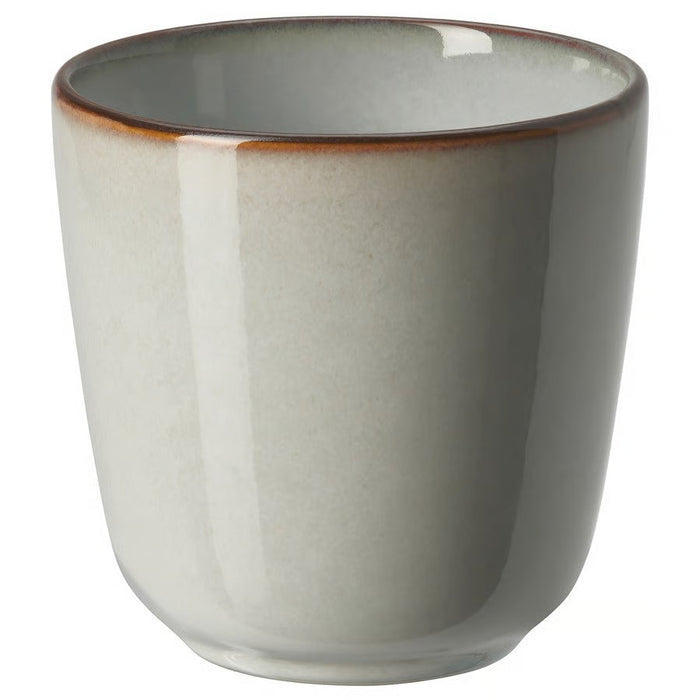 A single, stoneware IKEA GLADELIG espresso cup in a light grey color with a slightly darker, rustic brown rim, shown on a white background