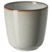 A single, stoneware IKEA GLADELIG espresso cup in a light grey color with a slightly darker, rustic brown rim, shown on a white background