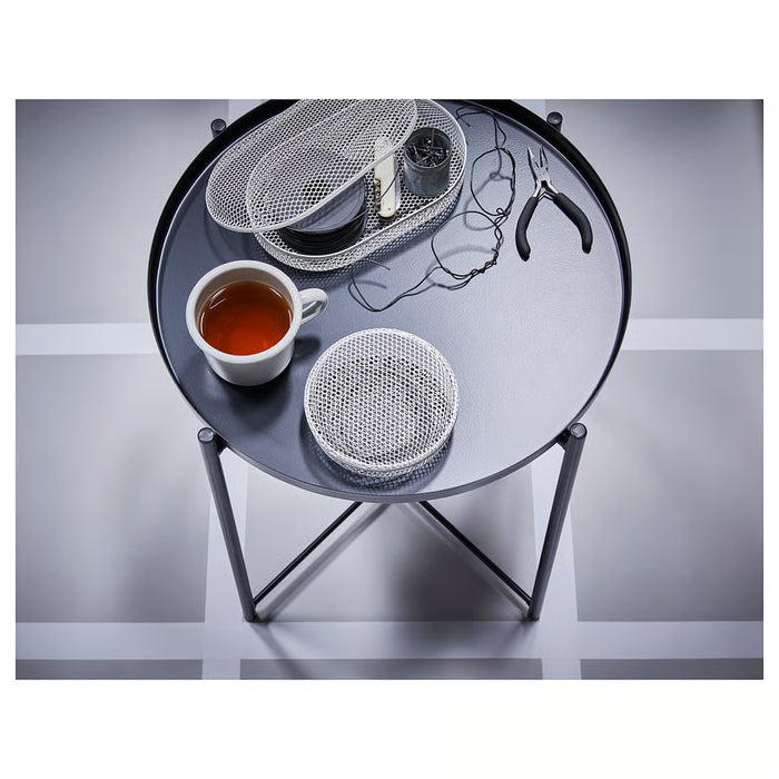 IKEA GLADOM tray table styled as bedside table with mug and tea cup in cosy room setting