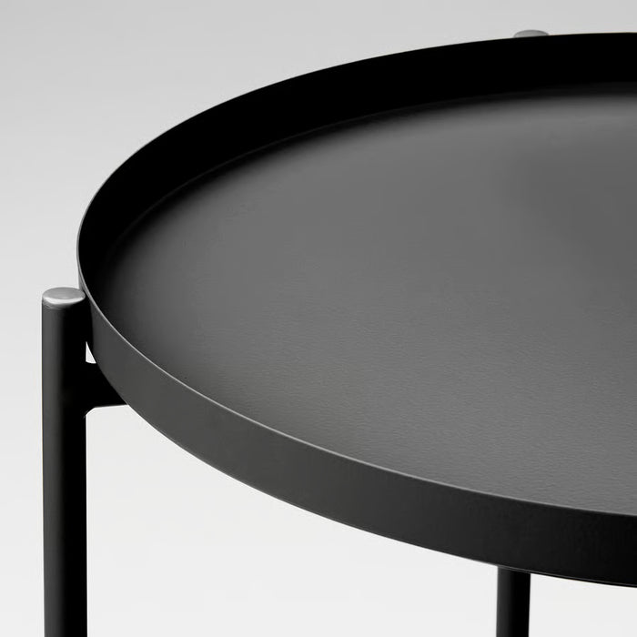  IKEA GLADOM black tray table close-up showing circular tray on sleek powder-coated steel stand