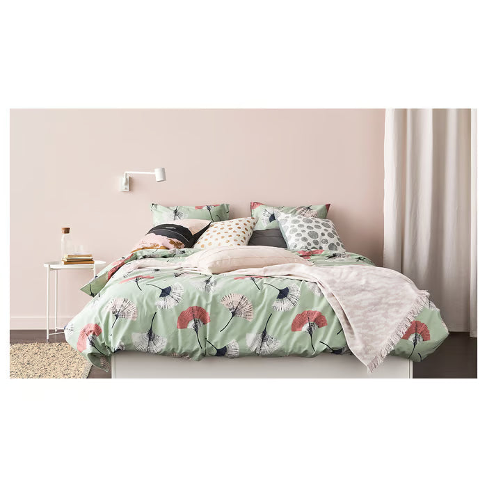 IKEA GLADOM white tray table in a compact bedroom used as a bedside table with phone and glass