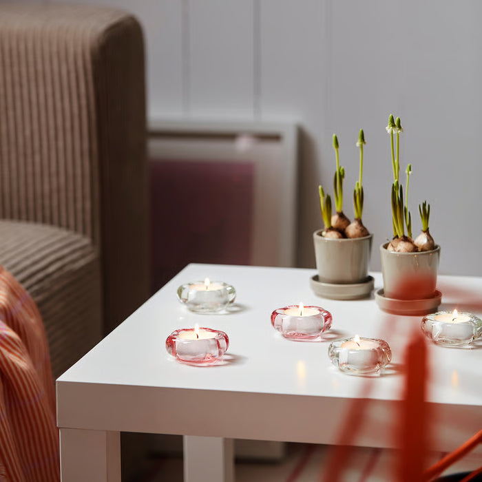 IKEA GLIMMA tealights arranged in a row on a surface creating soft ambient candlelight