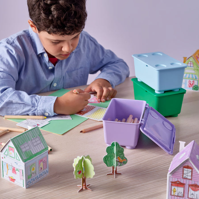 Close-up of IKEA GLIS colourful lidded boxes open showing small items like pencils and accessories inside