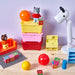 IKEA GLIS red pink yellow lidded boxes stacked together showing compact storage