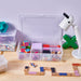 IKEA GLIS transparent box in a child's playroom storing small toys and craft supplies