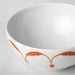 A white/orange Feldspar porcelain IKEA bowl with a smooth and glossy finish.