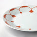 A close-up of the durable and stylish IKEA orange plate, featuring a glossy finish.