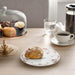 An image of a sleek and elegant orange plate from IKEA, perfect for serving meals at a dinner party