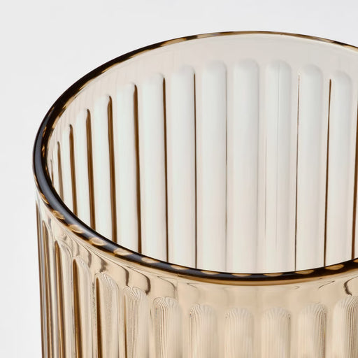 IKEA GRADVIS light brown glass plant pot styled with a small green plant on a wooden surface indoors