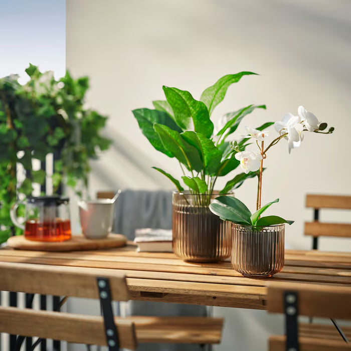 IKEA GRADVIS 9cm glass plant pot close-up showing grooved round shape and warm brown tint