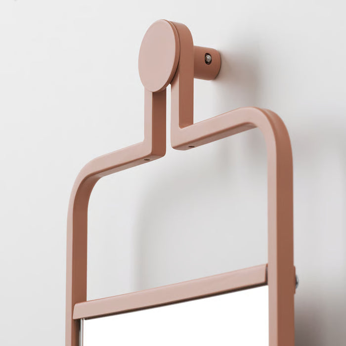 Close-up of IKEA GRANVÅG matte pink mirror frame mounted securely on wall