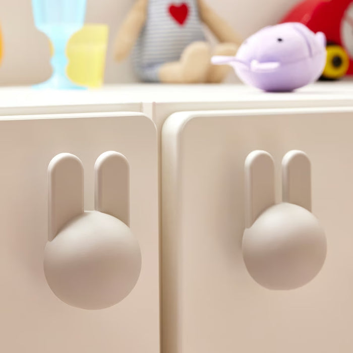 IKEA GREJSIMOJS bunny knob set of two light grey installed on wooden cabinet doors