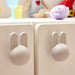 IKEA GREJSIMOJS bunny knob set of two light grey installed on wooden cabinet doors