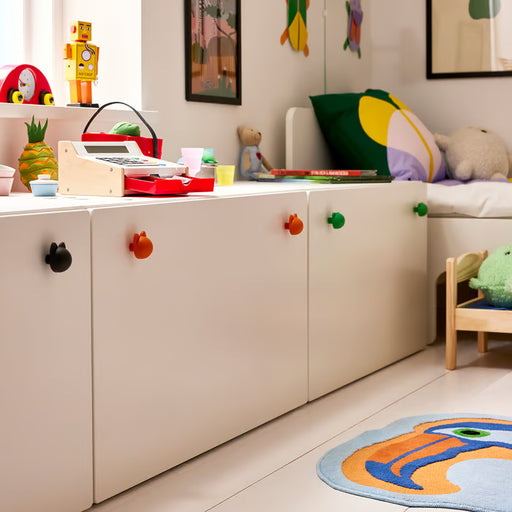 IKEA GREJSIMOJS orange cat knob installed on white wardrobe door children's room setting