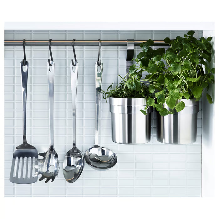 IKEA GRUNKA utensil set hanging on a metal wall rail in an organised kitchen with plants