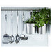 IKEA GRUNKA utensil set hanging on a metal wall rail in an organised kitchen with plants