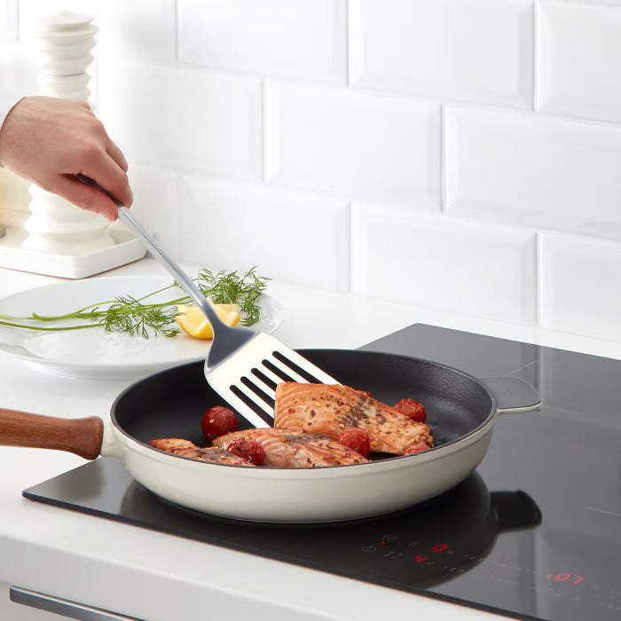 IKEA GRUNKA ladle scooping soup from a pot on an induction stove in a modern kitchen
