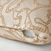 Close-up of a textured pillow with a subtle pattern on a light background