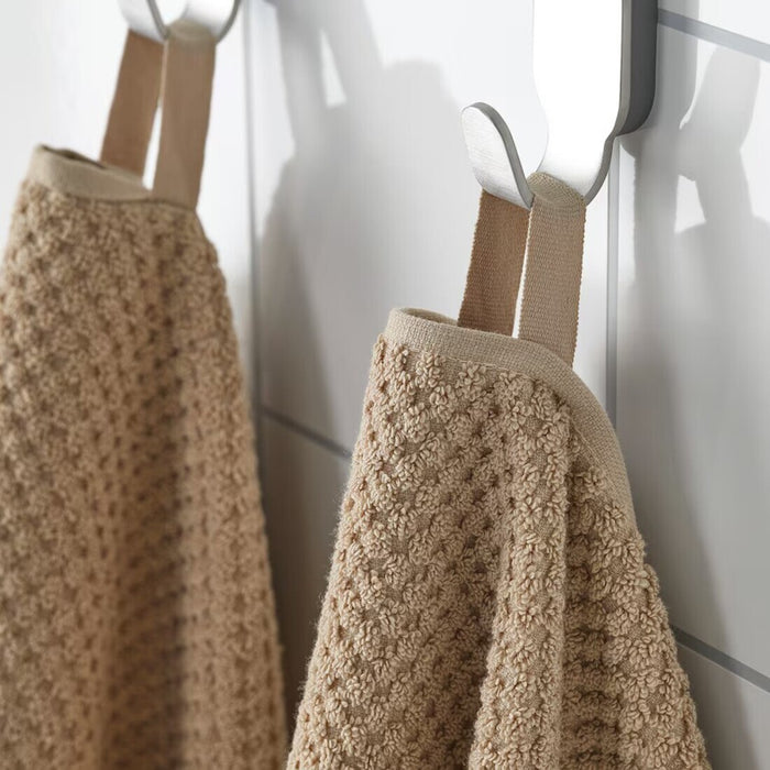 Digital Shoppy "IKEA washcloth hanging in a bathroom, showcasing its soft texture and absorbency."