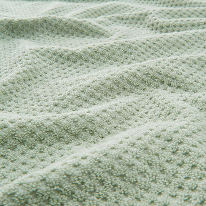 Digital Shoppy "Close-up of a stack of IKEA washcloths in different pastel colors."