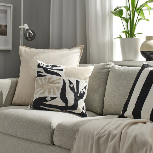 IKEA GURLI unbleached cushion cover on a sofa with black and white patterned cushions in a modern living room