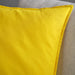 IKEA GURLI yellow cushion cover laid flat on a bed showing bright colour and neat stitching