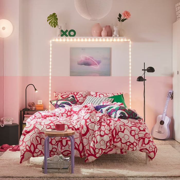 IKEA HÄRLIR pink floral duvet set styled on a bed in a cosy bedroom setting
