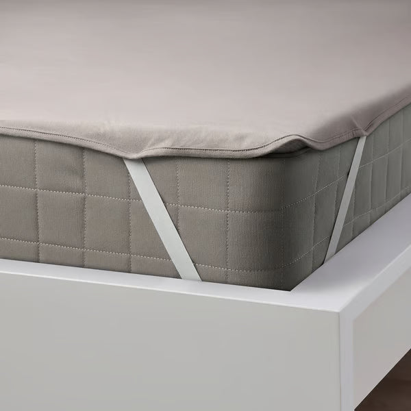 IKEA HAMPPALM grey waterproof mattress protector with elastic corner straps fitted on white bed