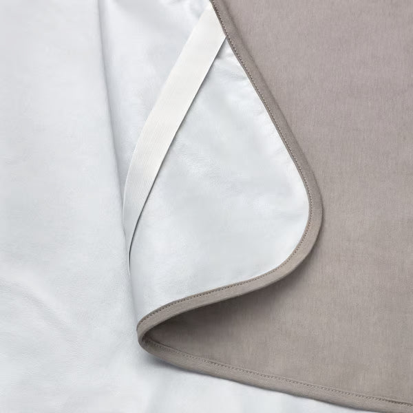 Close-up corner of IKEA HAMPPALM mattress protector showing smooth fabric and overlock stitching detail