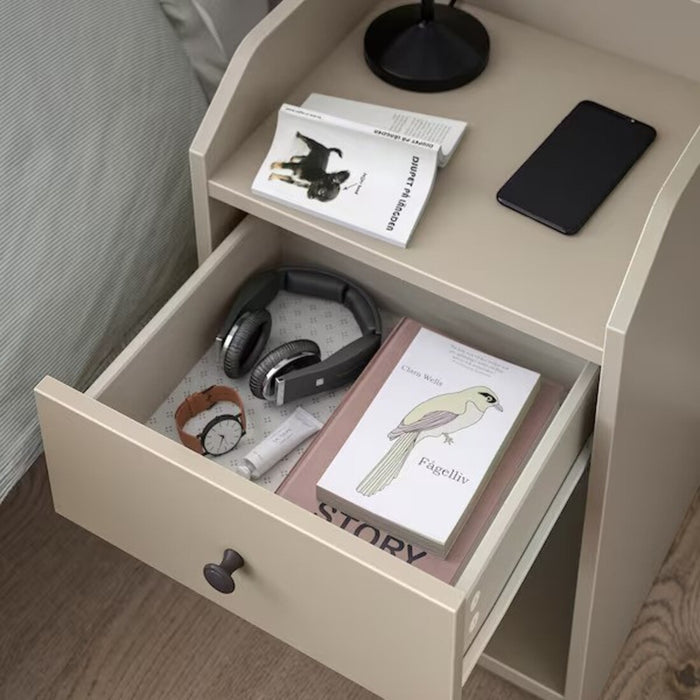 Detailed view of the HAUGA Bedside Table's practical storage options in beige