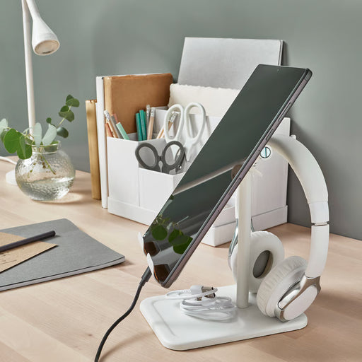  IKEA HAVREHOJ white tablet holder on office desk with headphones hooked on back and stationery in tray