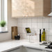 IKEA HAVREHOJ tablet holder on kitchen counter displaying recipe on tablet, next to plant and cutting board