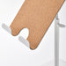 Close-up of IKEA HAVREHOJ tablet stand showing cork front surface, headphone hook, and bottom tray detail