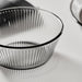 IKEA HAVSGÄDDA pink ribbed glass bowl next to a clear drinking glass and a spoon