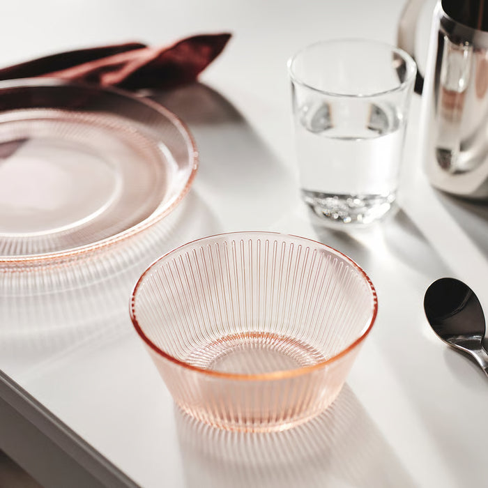 IKEA HAVSGÄDDA pink stripe glass bowl placed beside clear glass and spoon on table