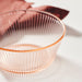 Multiple IKEA HAVSGÄDDA pink ribbed glass bowls stacked in soft natural light