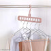 Digital Shoppy's foldable pink clothes hanger with 9 holes for organizing multiple garments vertically