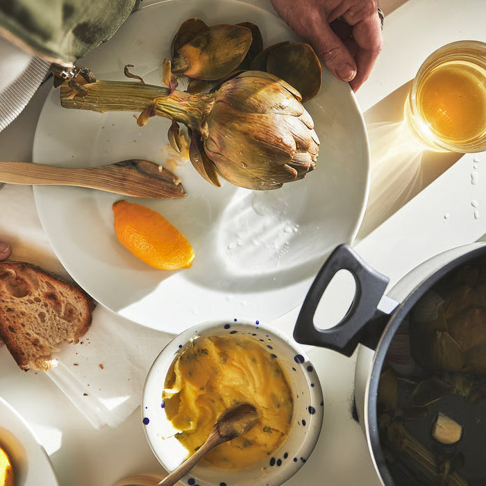 Roasted artichoke served with dipping sauce and bread cooked in IKEA HEMLAGAD pot
