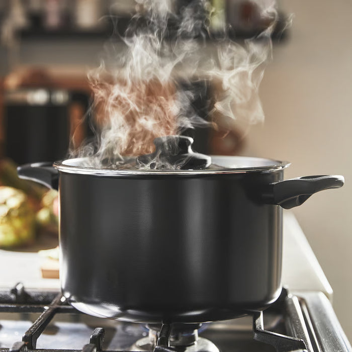 IKEA HEMLAGAD black saucepan boiling on stove showing even heat distribution