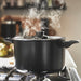 IKEA HEMLAGAD black saucepan boiling on stove showing even heat distribution