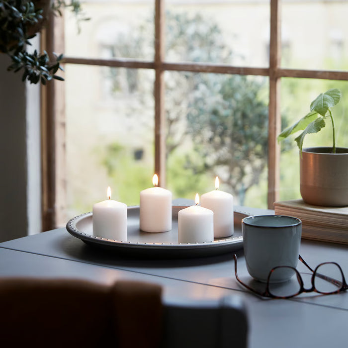 IKEA HEMSJÖ natural block candle lit with warm flame on wooden surface home décor setting