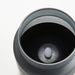 Close-up of IKEA HJULMÖJA LED candle with frosted glass and button in dark holder