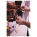Hands assembling IKEA HÖNEFOSS geometric hexagon mirrors with brown-tinted reflective surfaces
