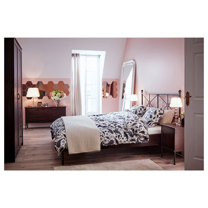  Elegant bedroom with IKEA HÖNEFOSS honeycomb mirrors arranged on pink wall above wooden dresser