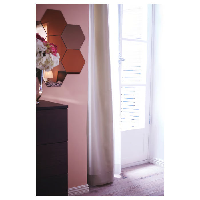 Room corner styled with large IKEA HÖNEFOSS mirror cluster on wall beside dark wood dresser
